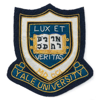 Blue blazer badge with Yale University crest on a dark blue background by Benson & Clegg.