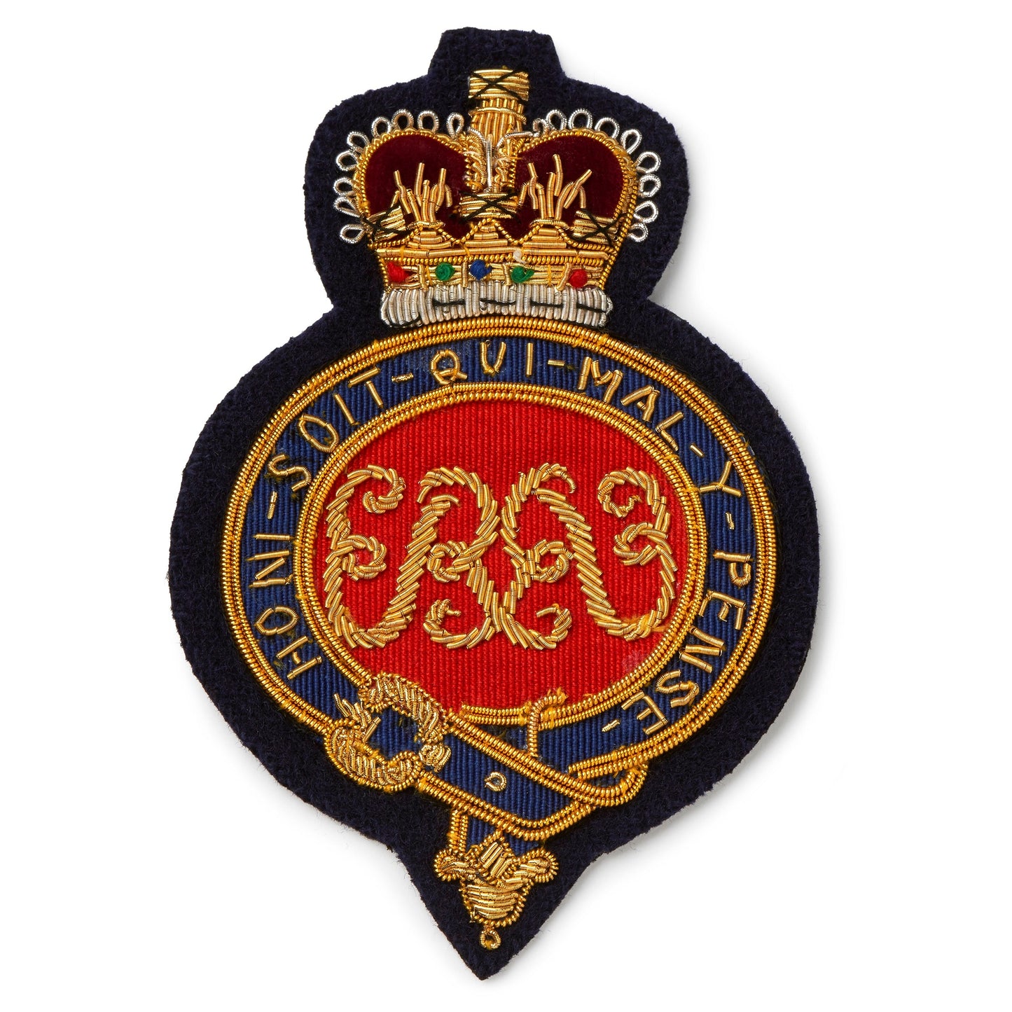 A brass Grenadier Guards Blazer Badge with detailed engraving, mounted on a dark blue background, by Benson & Clegg.