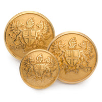 Gold City of London blazer button set displayed on a wooden table, featuring polished brass finish and classic design by Bens