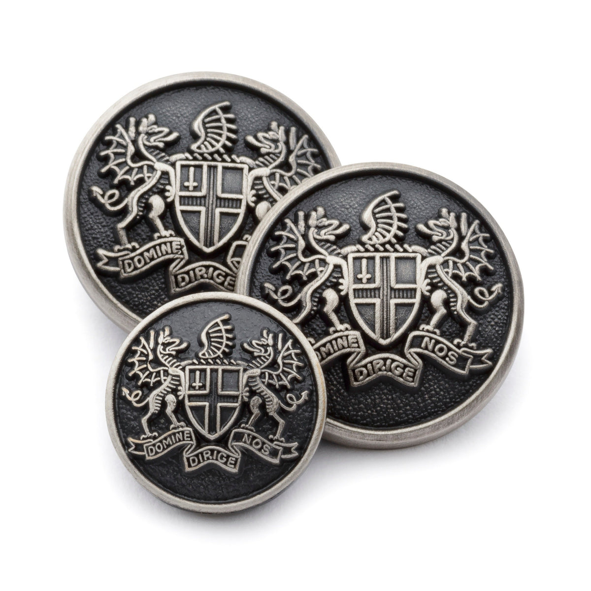 Antique silver blazer button set with detailed engraving, displayed on a dark background by Benson & Clegg.