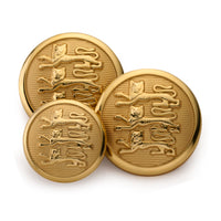 A golden three lions blazer button displayed on a black background with detailed engravings by Benson & Clegg.
