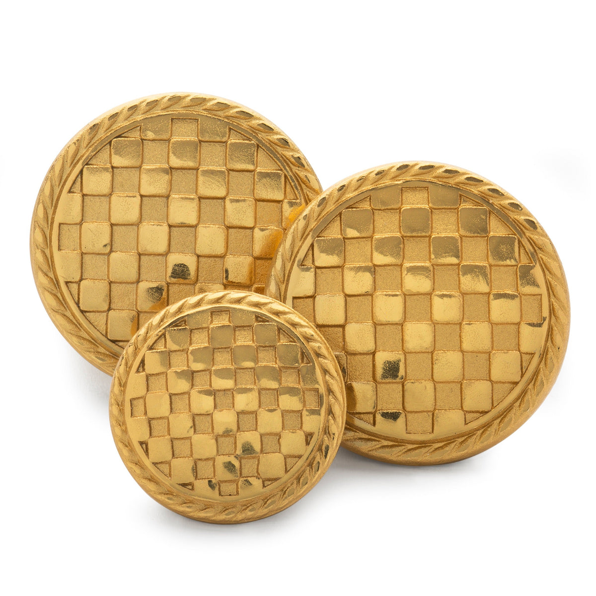 Black and white checkerboard blazer button with metallic edges, shown up close against a neutral background.