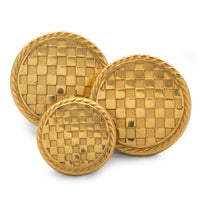 Black and white checkerboard blazer button with metallic edges, shown up close against a neutral background.