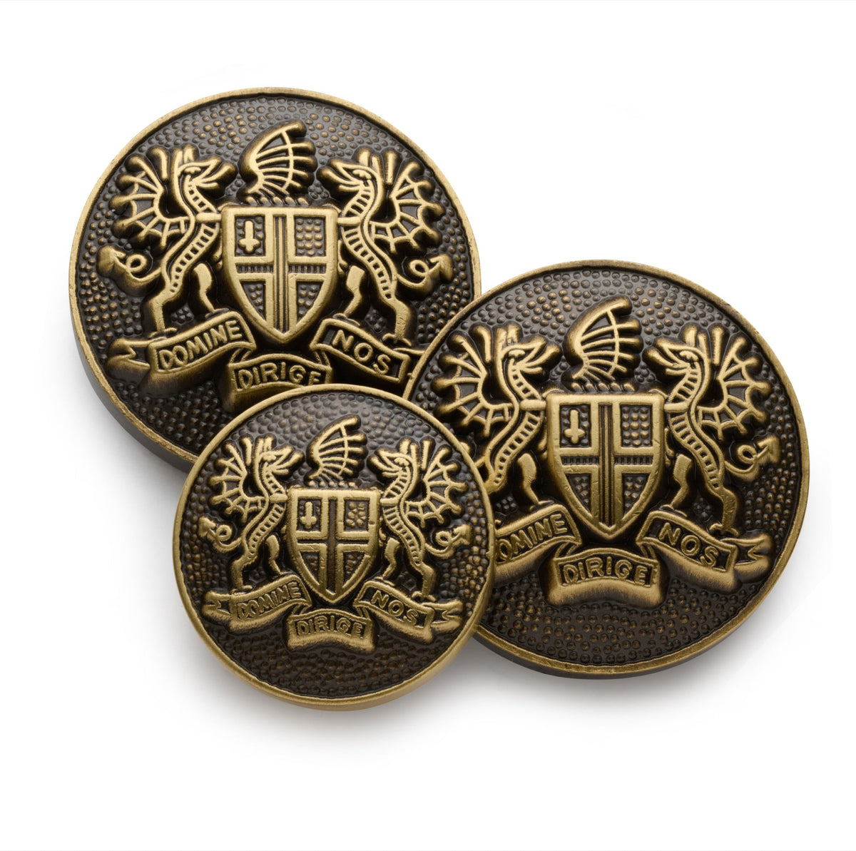 Bronze blazer button set displayed on a wooden table, featuring polished finish and intricate design by Benson & Clegg.
