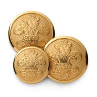 Gold fleur de lys blazer button with detailed engravings on a dark background by Benson & Clegg.