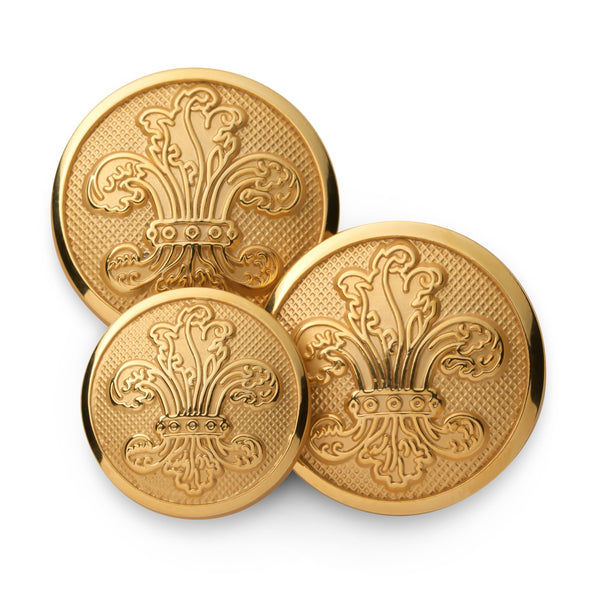 Gold fleur de lys blazer button with detailed engravings on a dark background by Benson & Clegg.