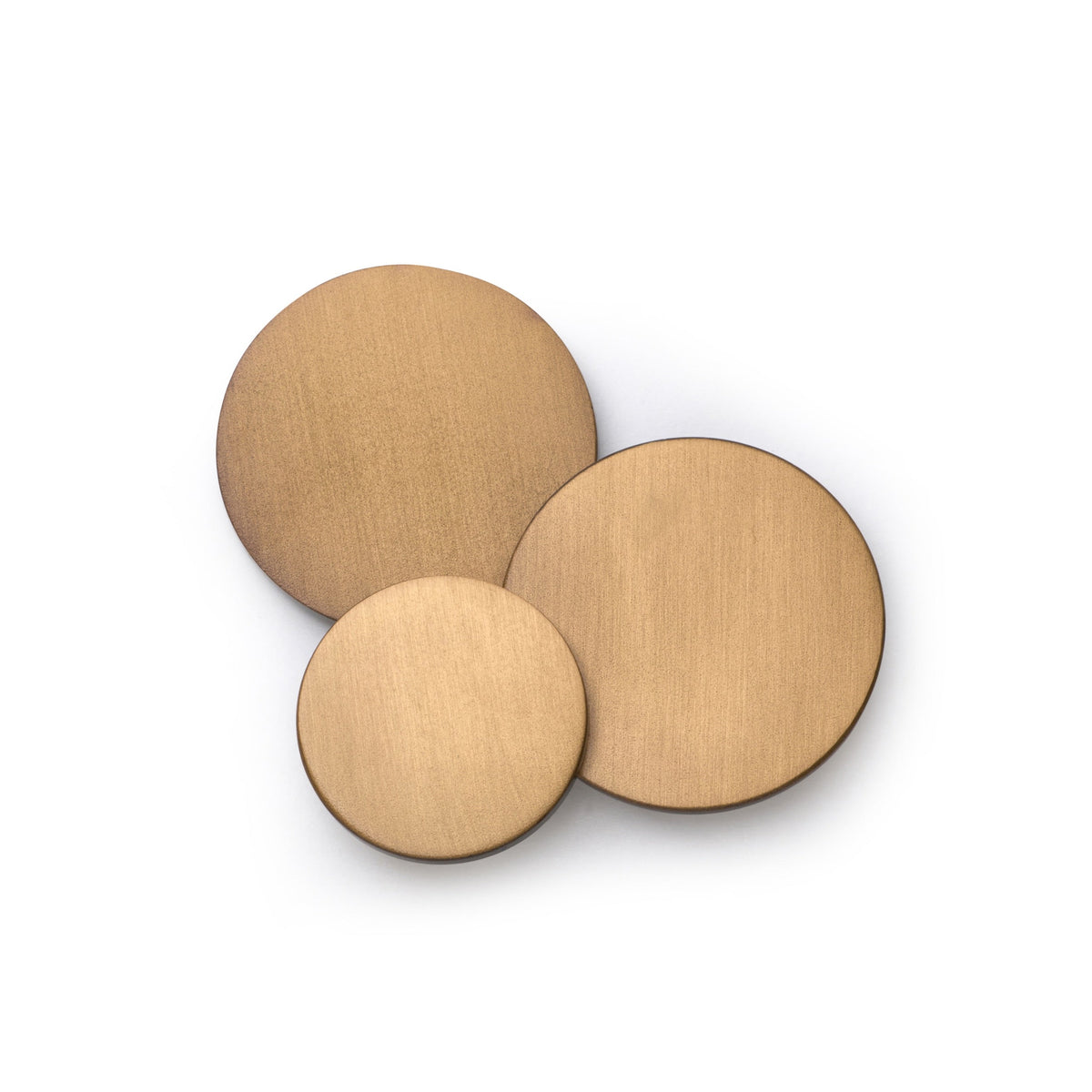 Brushed bronze blazer button with subtle texture and polished finish, shown up close, by Benson & Clegg.