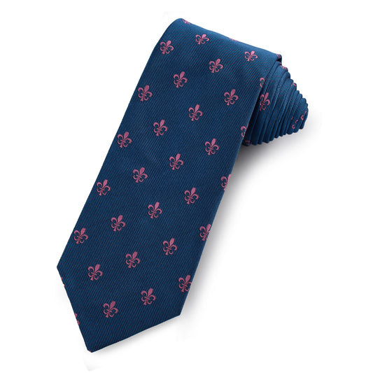A silk tie featuring a fleur de lys pattern in navy blue, shown folded neatly on a white background, by Benson & Clegg.