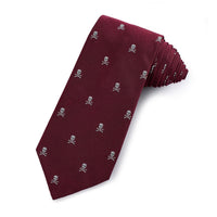 A red wine-colored silk tie with a skull and crossbones pattern, displayed horizontally on a white background by Benson & Cle
