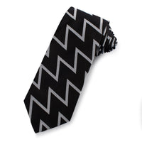 Black and silver silk tie with subtle sheen, styled around a collar, by Benson & Clegg.