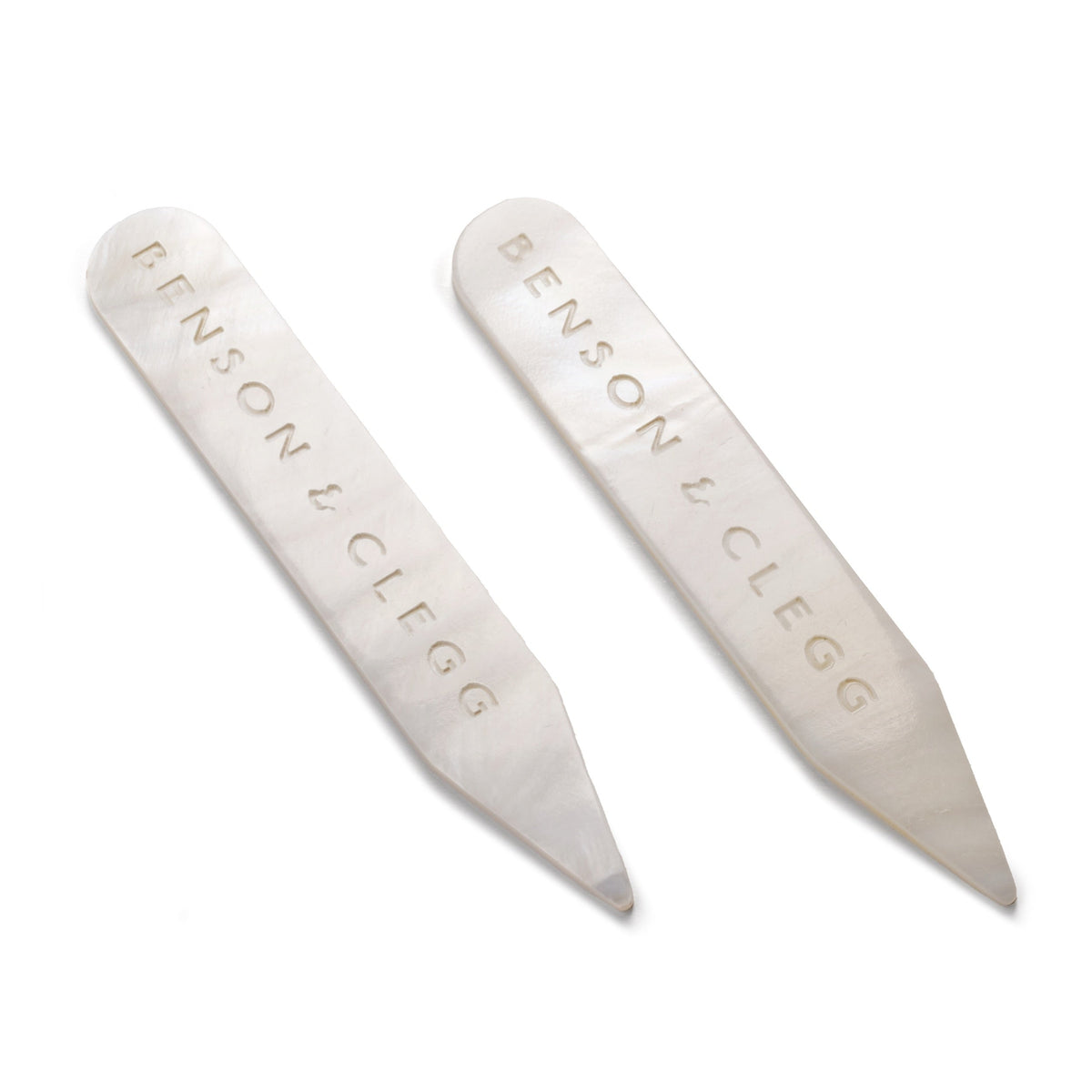 White mother of pearl collar stiffeners styled on a black shirt collar by Benson & Clegg.