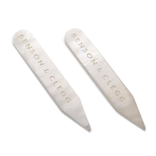 White mother of pearl collar stiffeners styled on a black shirt collar by Benson & Clegg.
