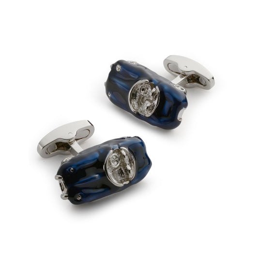 Black metal cufflinks with a sleek design worn on a formal shirt by Benson & Clegg.