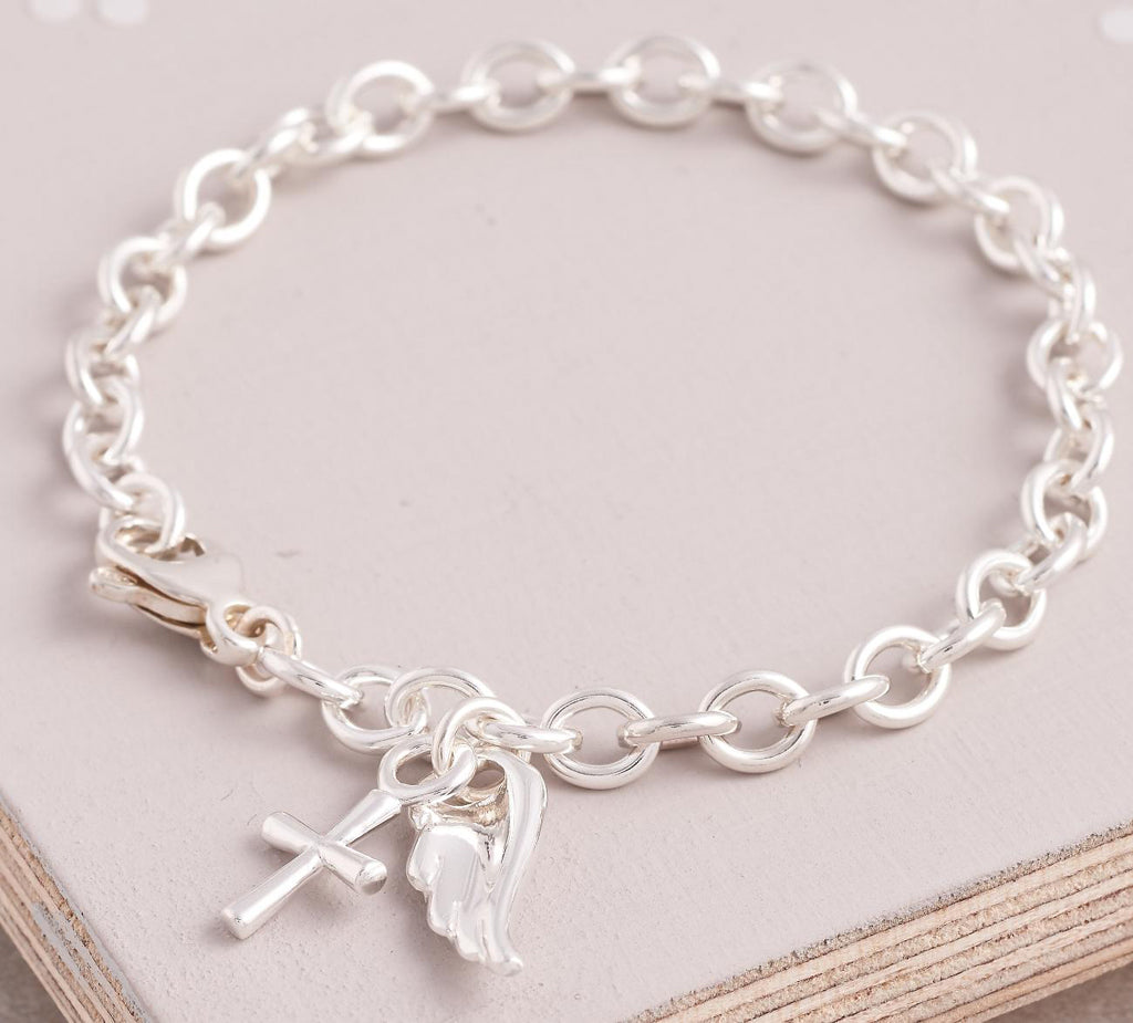 Silver charm bracelet with a delicate cross charm, featuring intricate detailing and a classic design by Scarlett Jewellery.