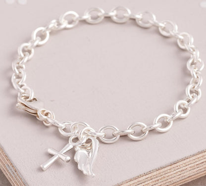 Silver charm bracelet with a delicate cross charm, featuring intricate detailing and a classic design by Scarlett Jewellery.