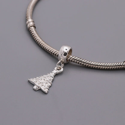 A silver Christmas tree charm with personalized engraving, displayed on a white background, by Scarlett Jewellery.