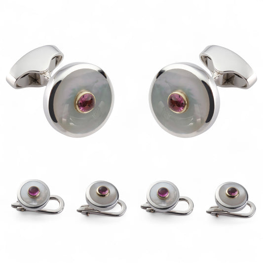 A pink tourmaline and sterling silver dress set displayed on a velvet tray by Benson & Clegg