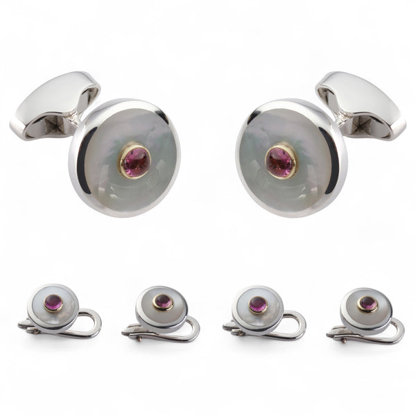 A pink tourmaline and sterling silver dress set displayed on a velvet tray by Benson & Clegg