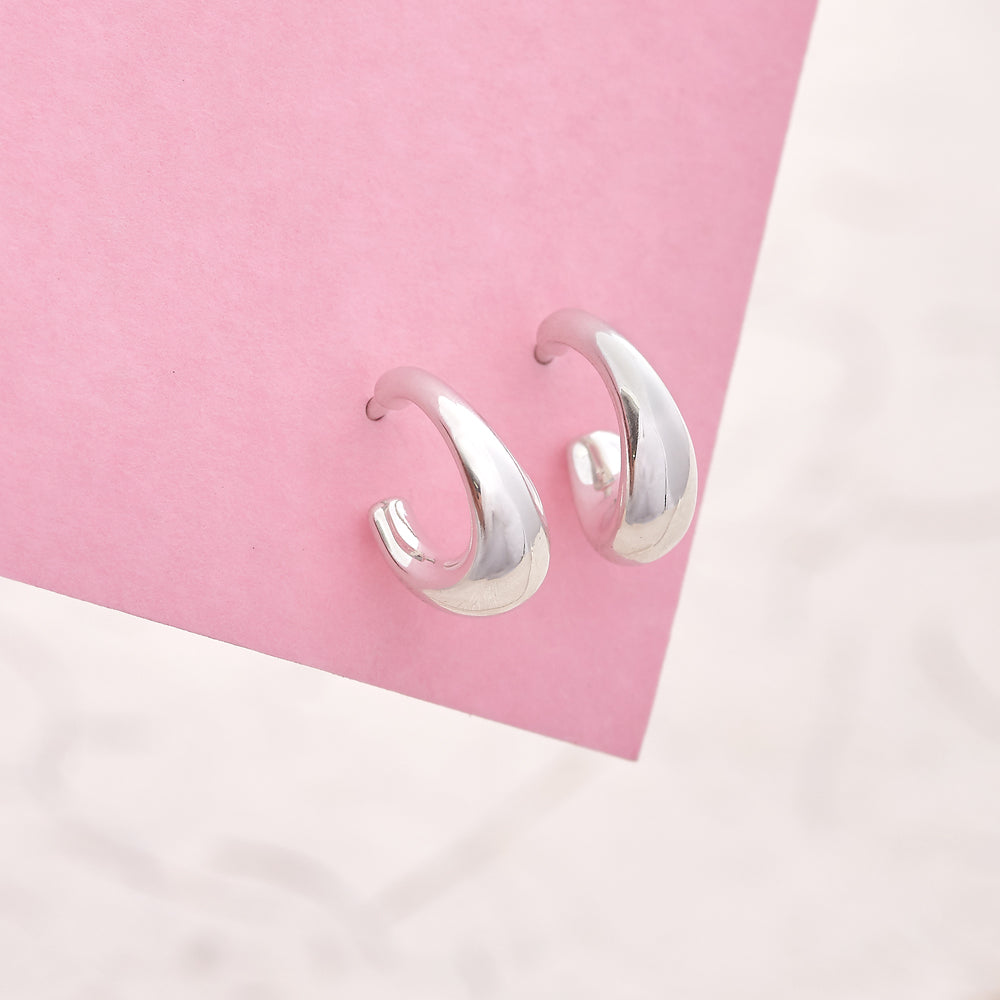Silver hoop earrings with a classic huggie design by Scarlett Jewellery.