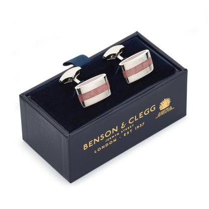 Contemporary rhodochrosite cufflinks with polished red and white stone accents, displayed on a black velvet background by Ben