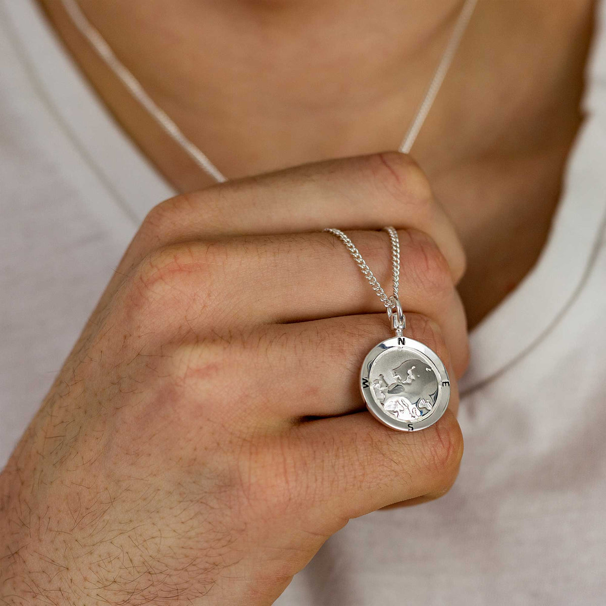 A silver chain necklace featuring a personalized Europe map globe design by Scarlett Jewellery.