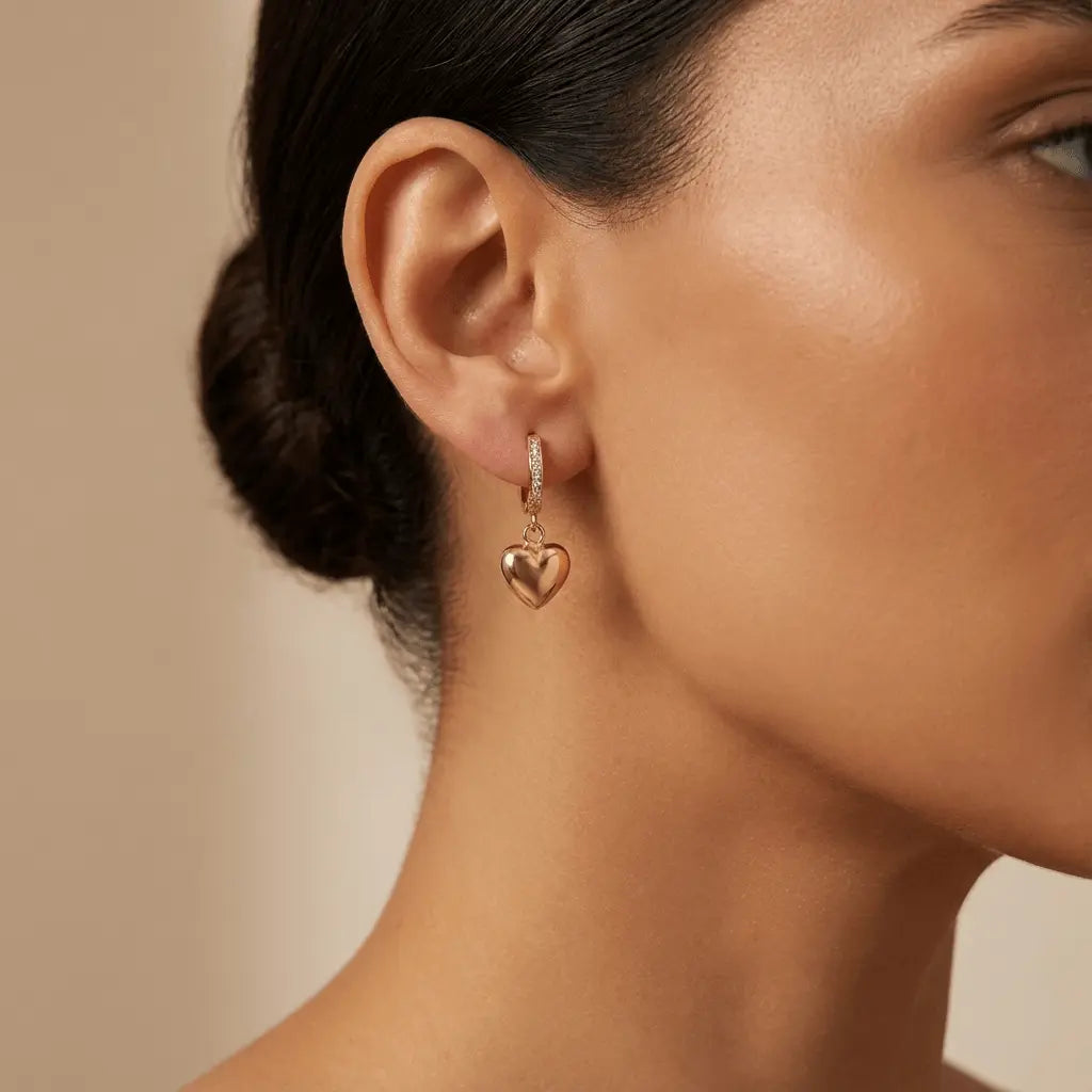A golden heart drop hoop earring in 14ct gold by Majestic Jewellery