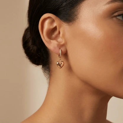 A golden heart drop hoop earring in 14ct gold by Majestic Jewellery