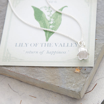 Silver lily of the valley flower charm with delicate details, styled on a necklace chain by Scarlett Jewellery.