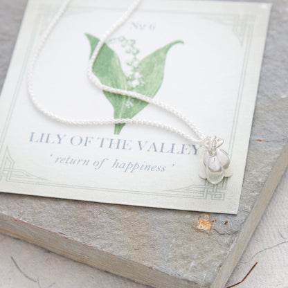 Silver lily of the valley flower charm with delicate details, styled on a necklace chain by Scarlett Jewellery.