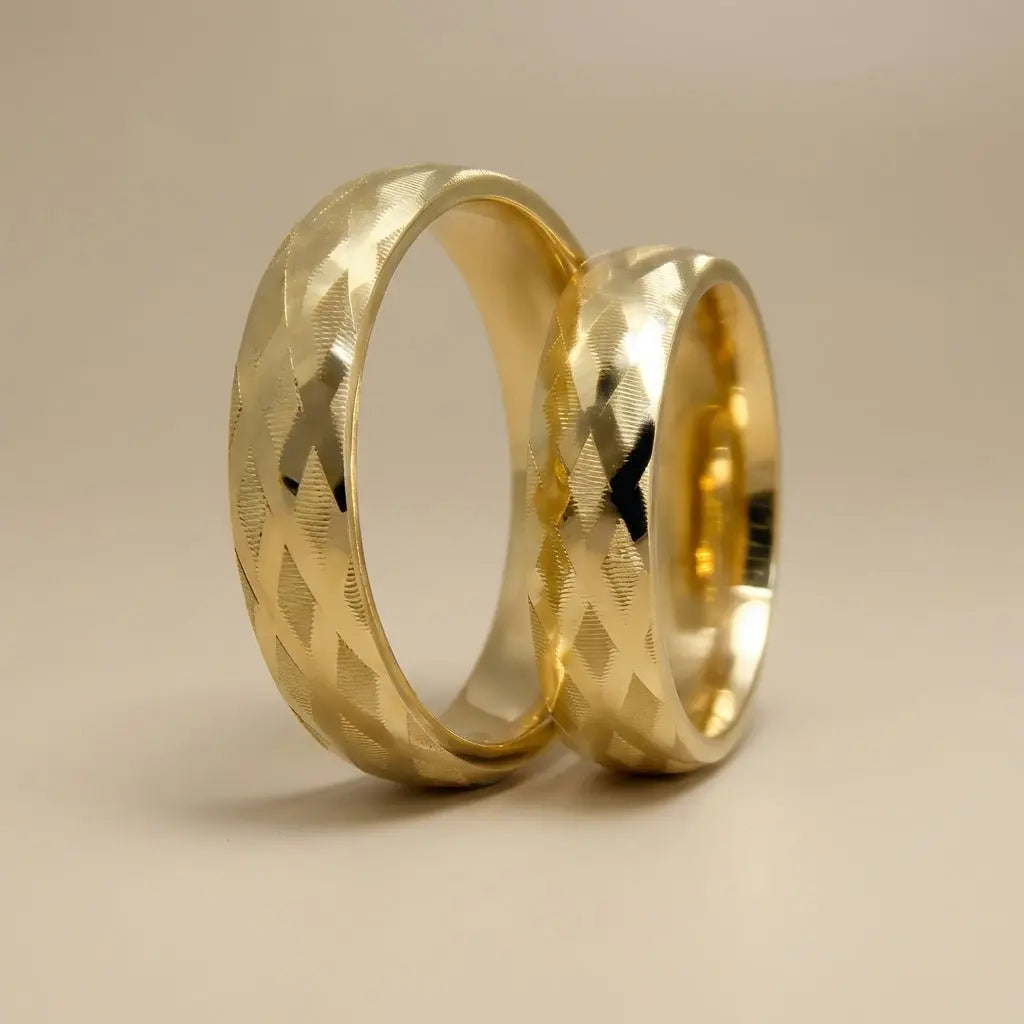 A 5mm gold wedding band with cross faceted design in 9ct gold, shown against a soft background by Majestic Jewellery.