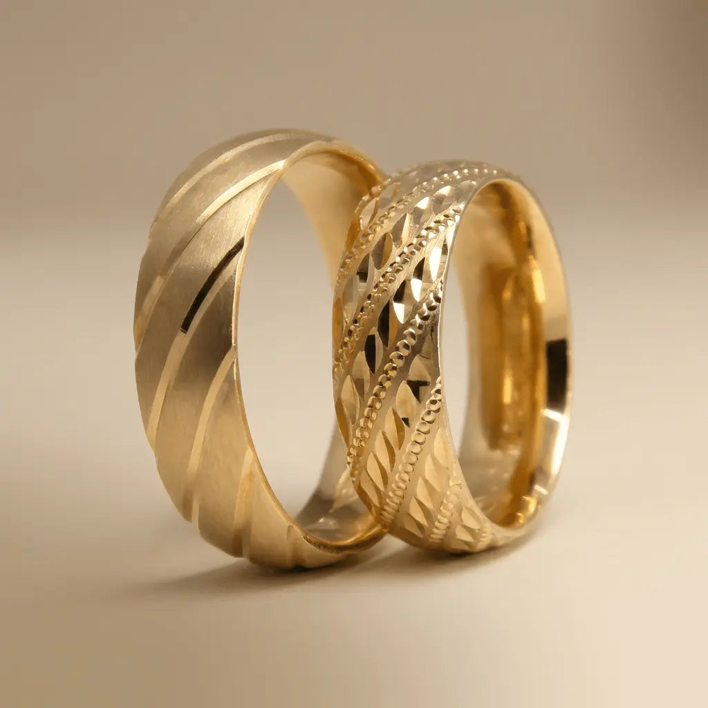 A 6mm gold wedding band with a diagonal lattice faceted design in 14ct gold worn on a finger by Majestic Jewellery.