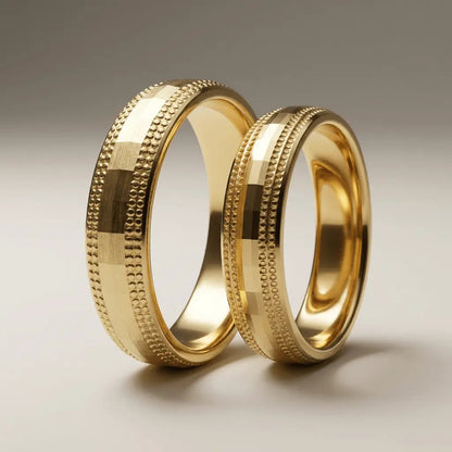 A 5mm gold wedding band with faceted milgrain detailing in 9ct gold, shown against a neutral background by Majestic Jewellery