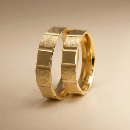 A 5mm gold wedding band with a segmented block texture in 14ct gold, displayed on a white background by Majestic Jewellery.