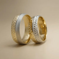 A two-tone 7mm gold wedding band with faceted details in 9ct, 14ct, and 18ct gold by Majestic Jewellery.