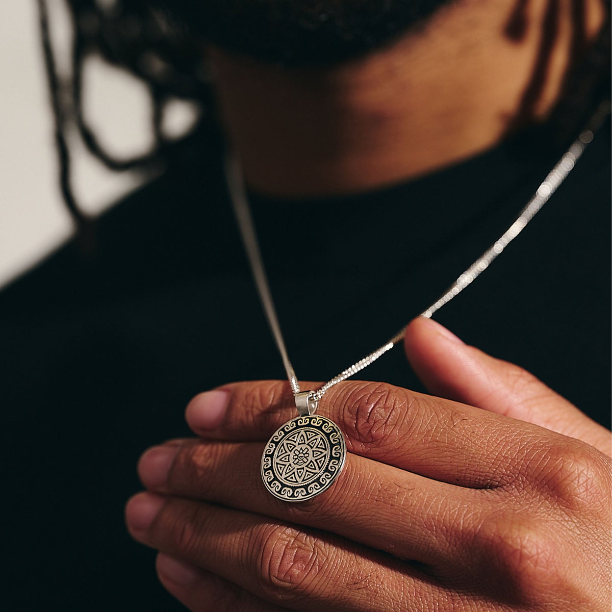 Silver necklace featuring an Aztec Ollin travel mandala design with personalized engraving by Scarlett Jewellery.