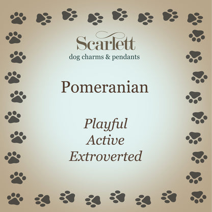 A silver Pomeranian dog charm shaped like a tiny pup, detailed with realistic features, by Scarlett Jewellery.