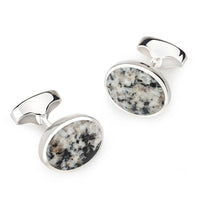 Sterling silver oval cufflinks with a textured Donegal stone finish, detailed close-up shot by Benson & Clegg.