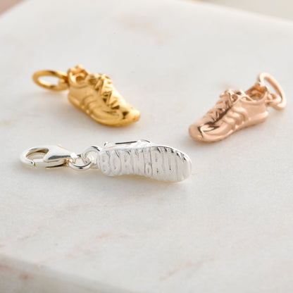 Silver charm with detailed etching on a running shoe by Scarlett Jewellery.