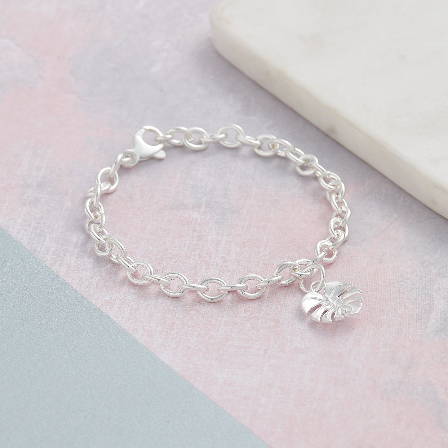 Silver charm bracelet featuring a monstera palm design by Scarlett Jewellery.