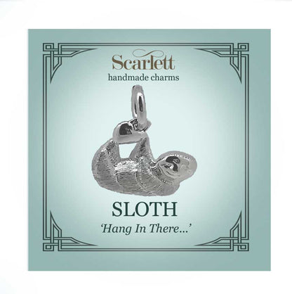 Sloth silver charm with intricate detailing, displayed on a soft pink background by Scarlett Jewellery.