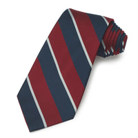 Royal Air Force three-fold silk tie in navy blue with gold accents, folded neatly on a wooden stand by Benson & Clegg.