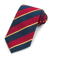 Dark blue three-fold silk reppe tie with intricate pattern, worn on a formal shirt by Benson & Clegg.