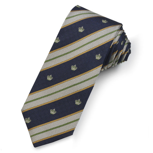A green silk reppe tie with a textured pattern worn around a neck by Benson & Clegg.