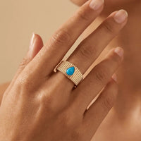 A textured turquoise drop ring in 14ct gold by Majestic Jewellery