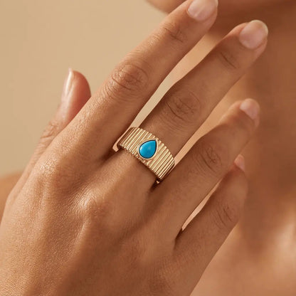 A textured turquoise drop ring in 14ct gold by Majestic Jewellery