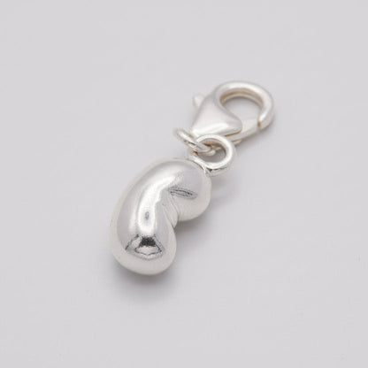 Silver baby bean charm with delicate detailing, styled on a necklace chain by Scarlett Jewellery.