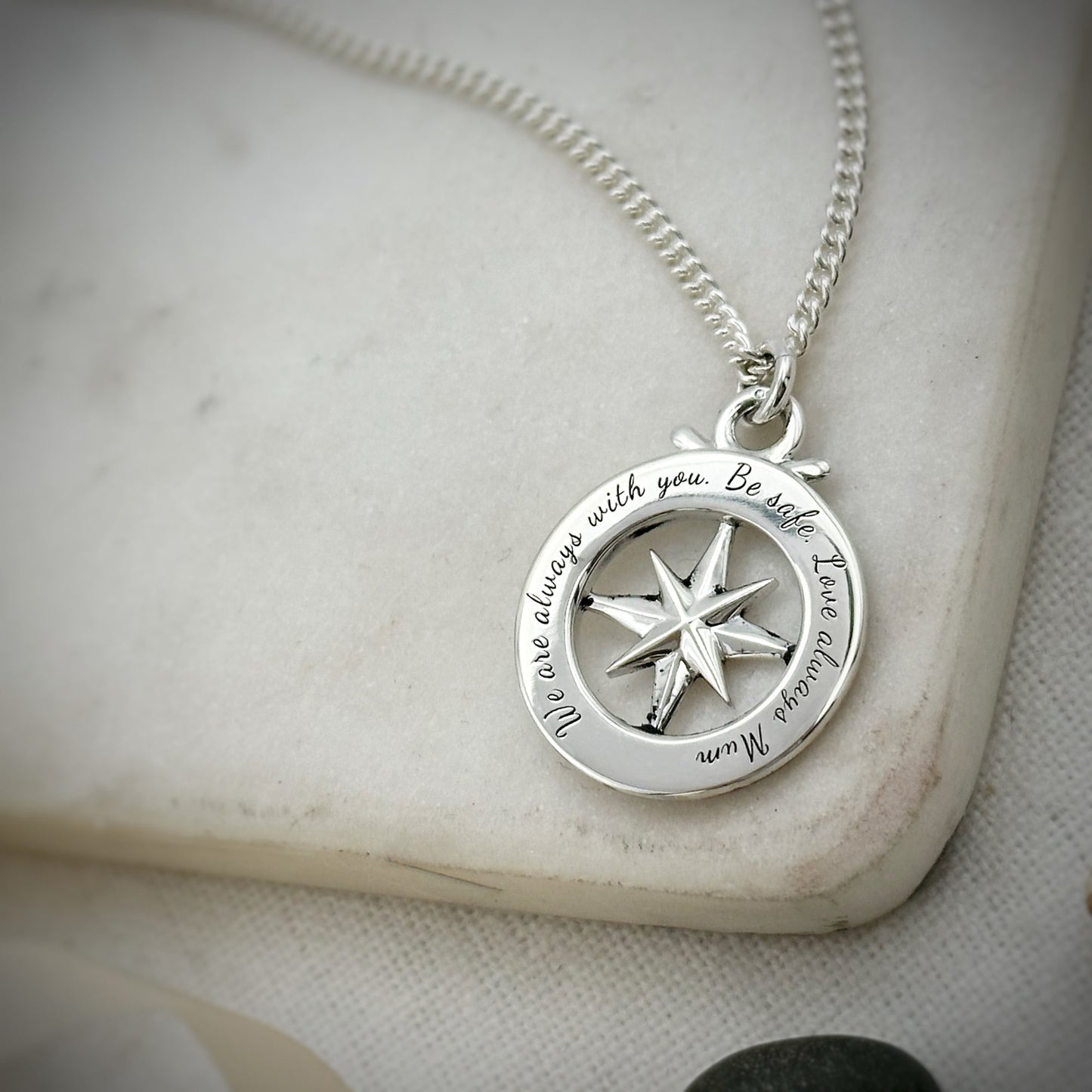 Large silver compass necklace featuring an outline of St Christopher, styled as a pendant by Scarlett Jewellery.