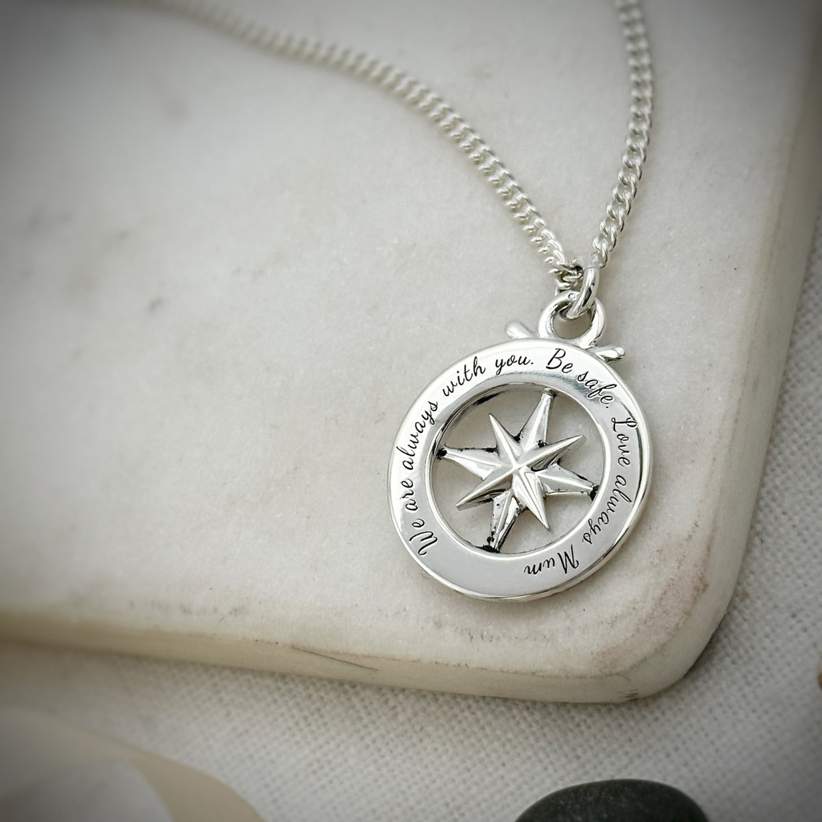 Large silver compass necklace featuring an outline of St Christopher, styled as a pendant by Scarlett Jewellery.