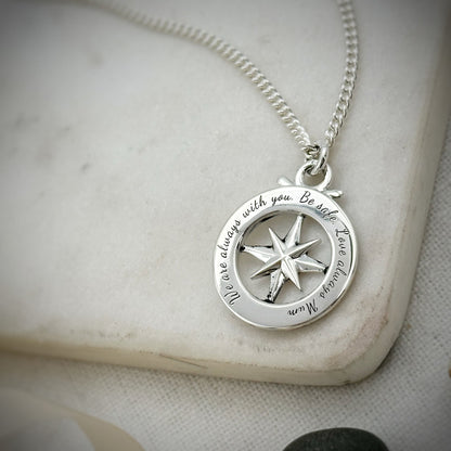 Large silver compass necklace featuring an outline of St Christopher, styled as a pendant by Scarlett Jewellery.