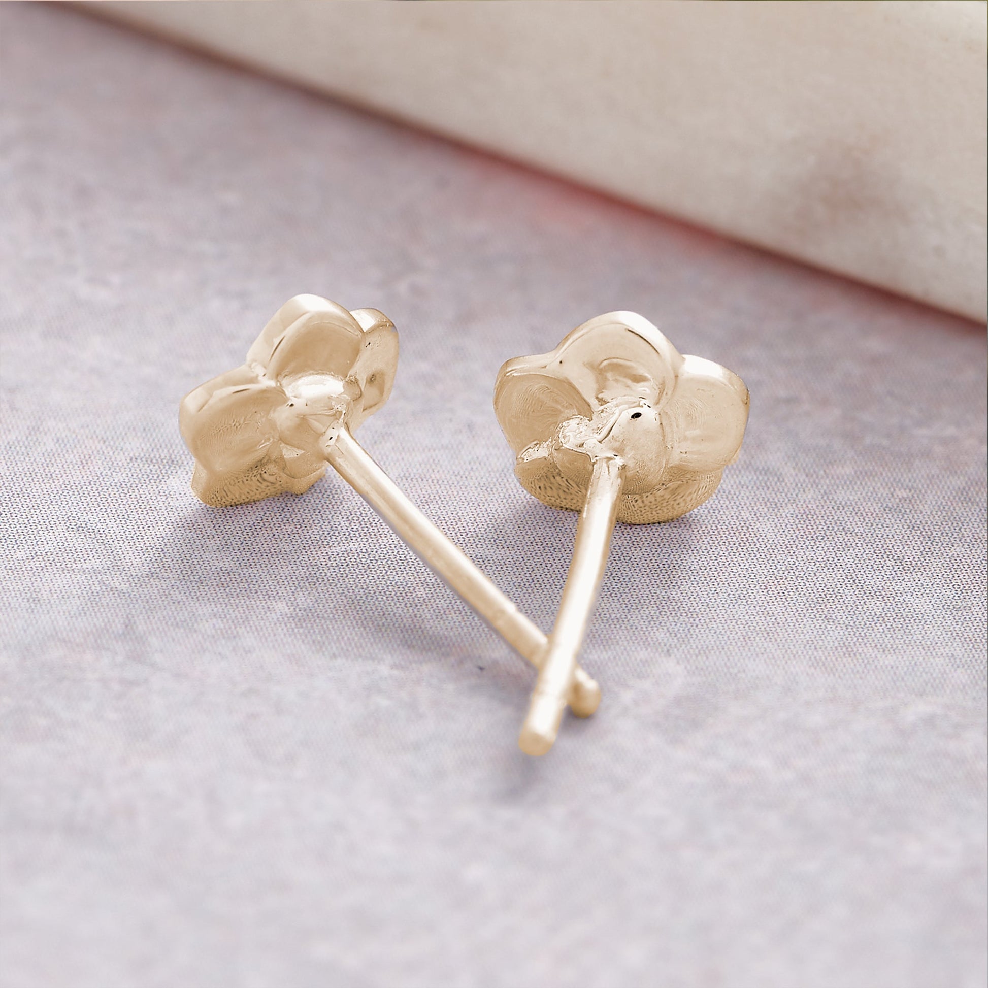 Tiny gold vermeil stud earrings with a delicate forget-me-not design by Scarlett Jewellery.